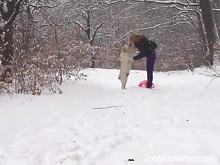 Clothed babe tries dog dick in the snow and loves the outcome