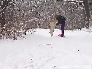 Clothed babe tries dog dick in the snow and loves the outcome